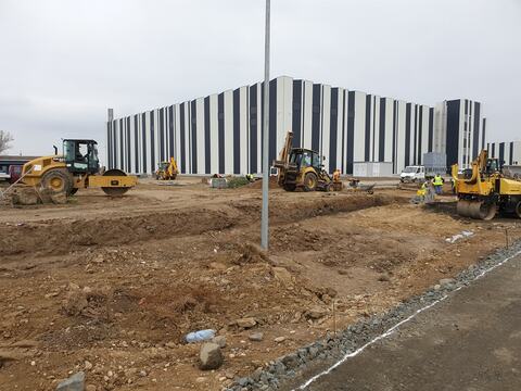 Platforms and site roads in progress in front of the Alu-Menziken hall, compacted with a roller